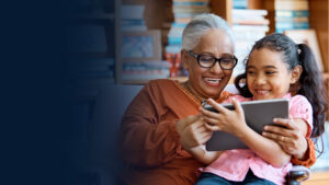 Smiling females using digital tablet at home stock photo